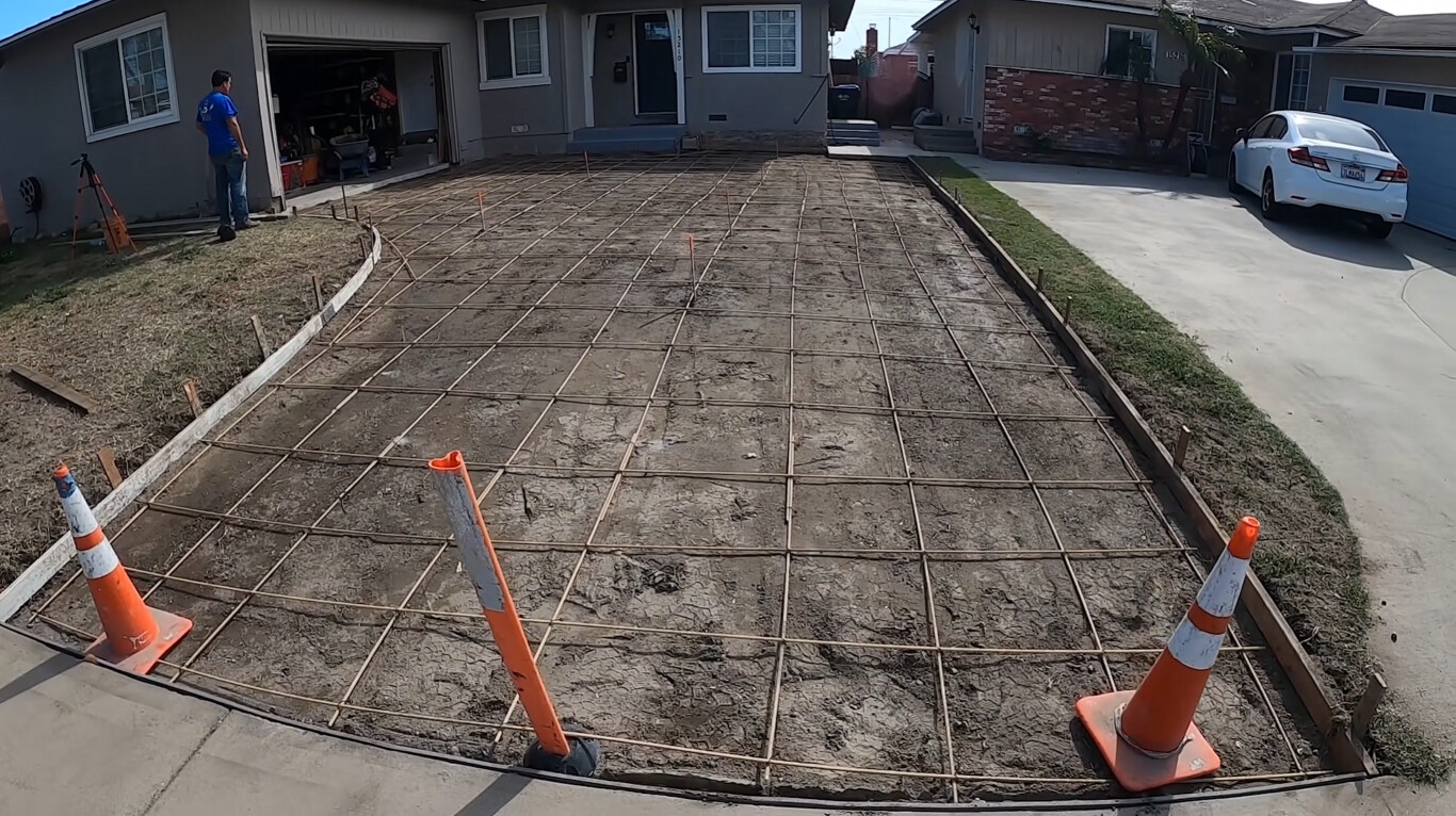 Proper driveway base preparation with rebar grid for long-lasting concrete in Champaign, IL