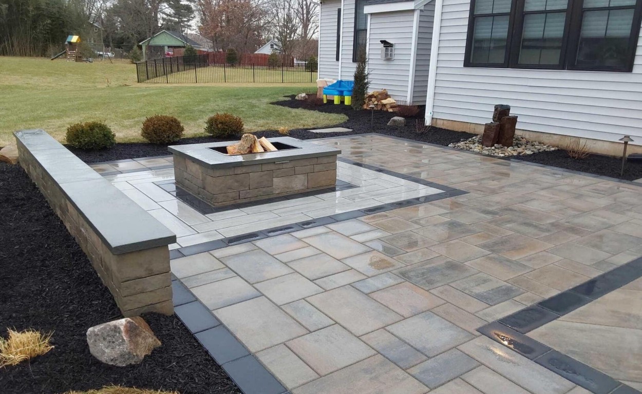 Custom concrete patio with firepit and decorative pavers in Champaign, IL